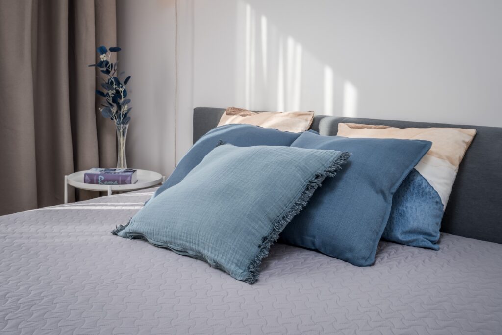 Fotografía inmobiliaria de dormitorio luminoso con cama doble y decoración minimalista